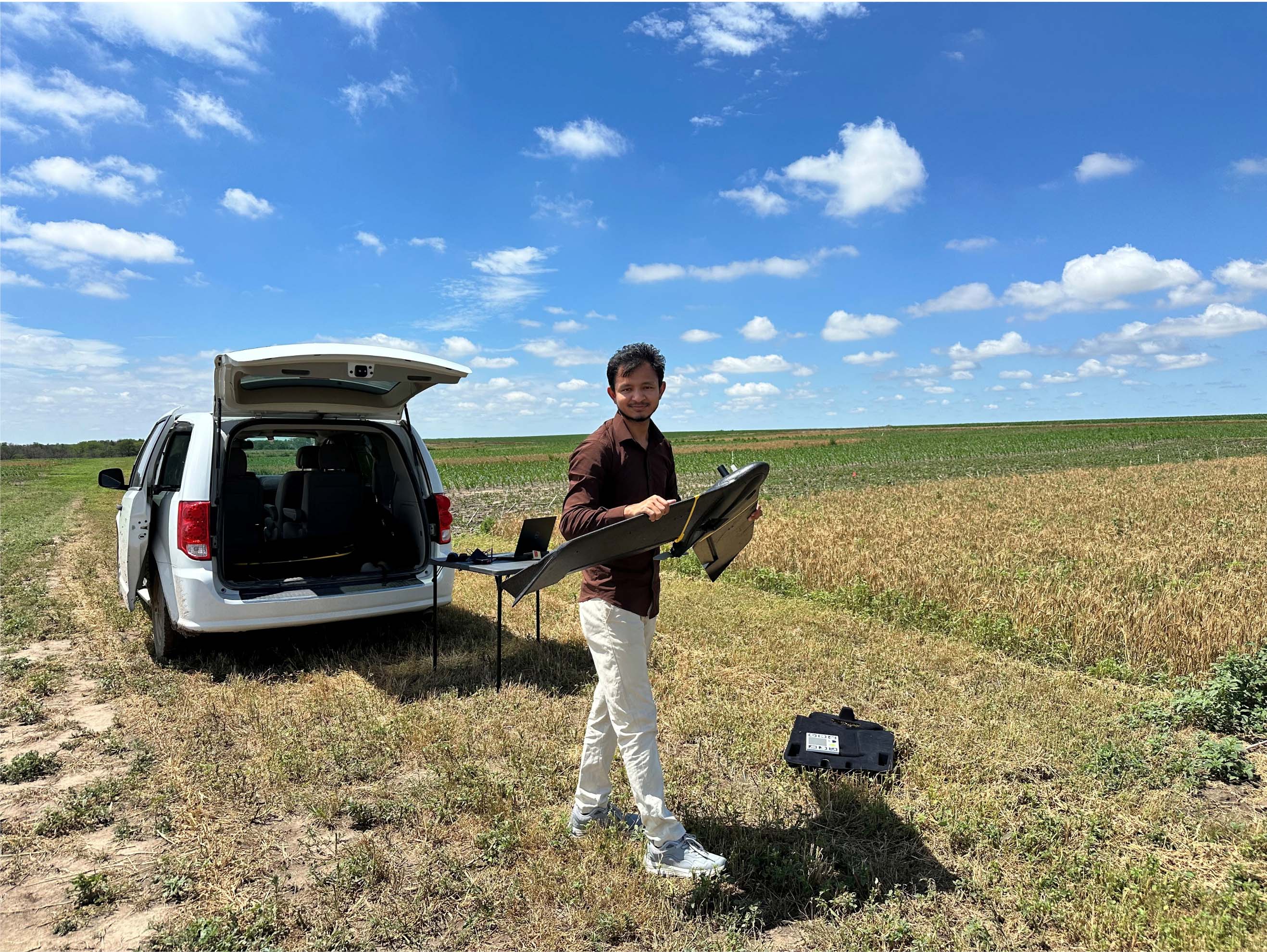 Sangam Bishwakarma collecting drone images and recording GPS location of the plots for his MS thesis work.